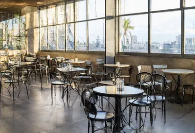 Rooftop table with warm window light, wide angle