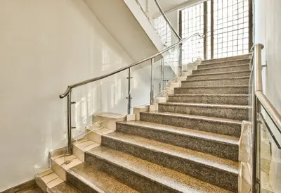 Lobby staircase with warm window light, low angle