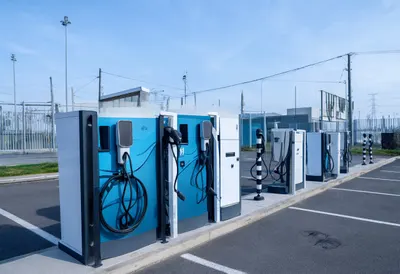 Ev charging plaza with cool blue light, wide angle